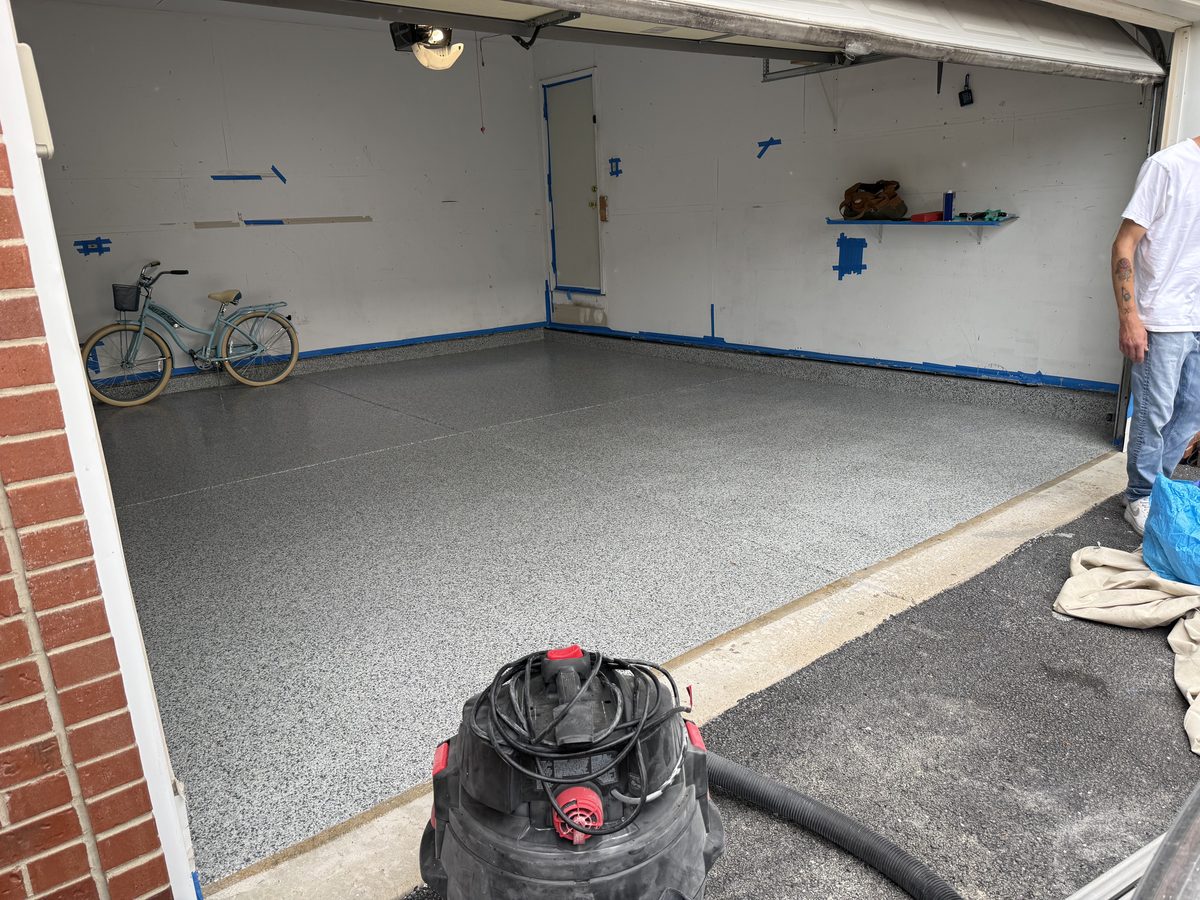 Finished flake floor inside the garage — clean, reflective gray-flake coating