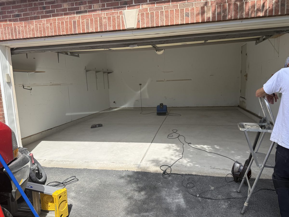 Garage cleared and staged for mechanical grinding before any coating goes down